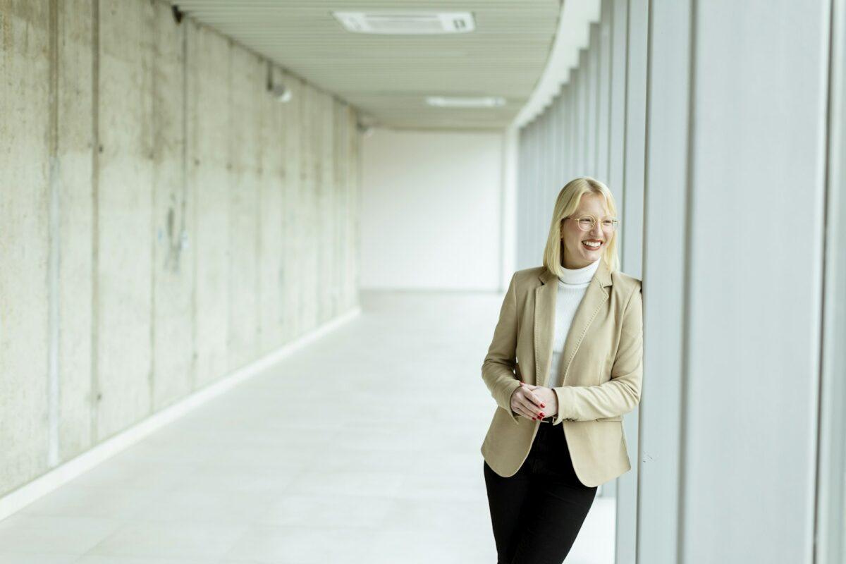 Business woman standing in the office corridor