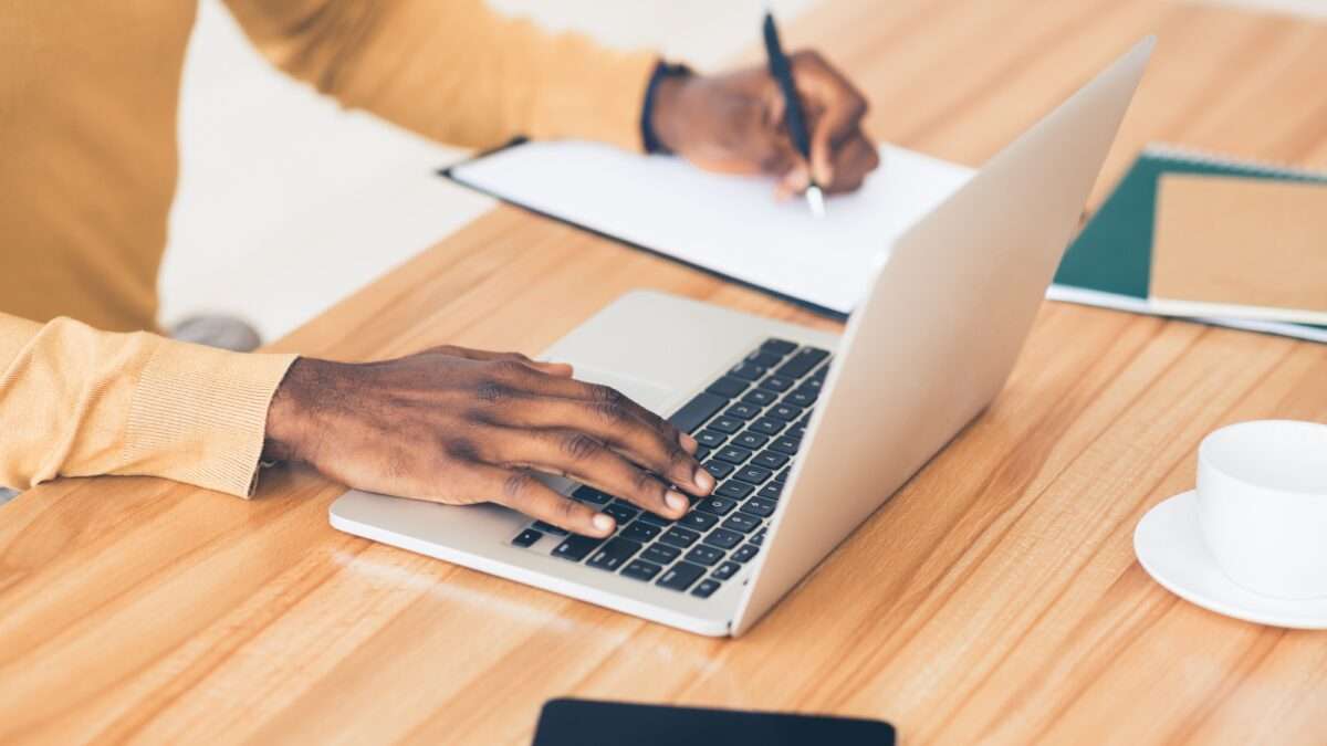 Why Your E-Commerce Website Isn’t Making Sales (And 8 Things You Can Do About It) 4 Unrecognizable black guy working on his laptop and writing