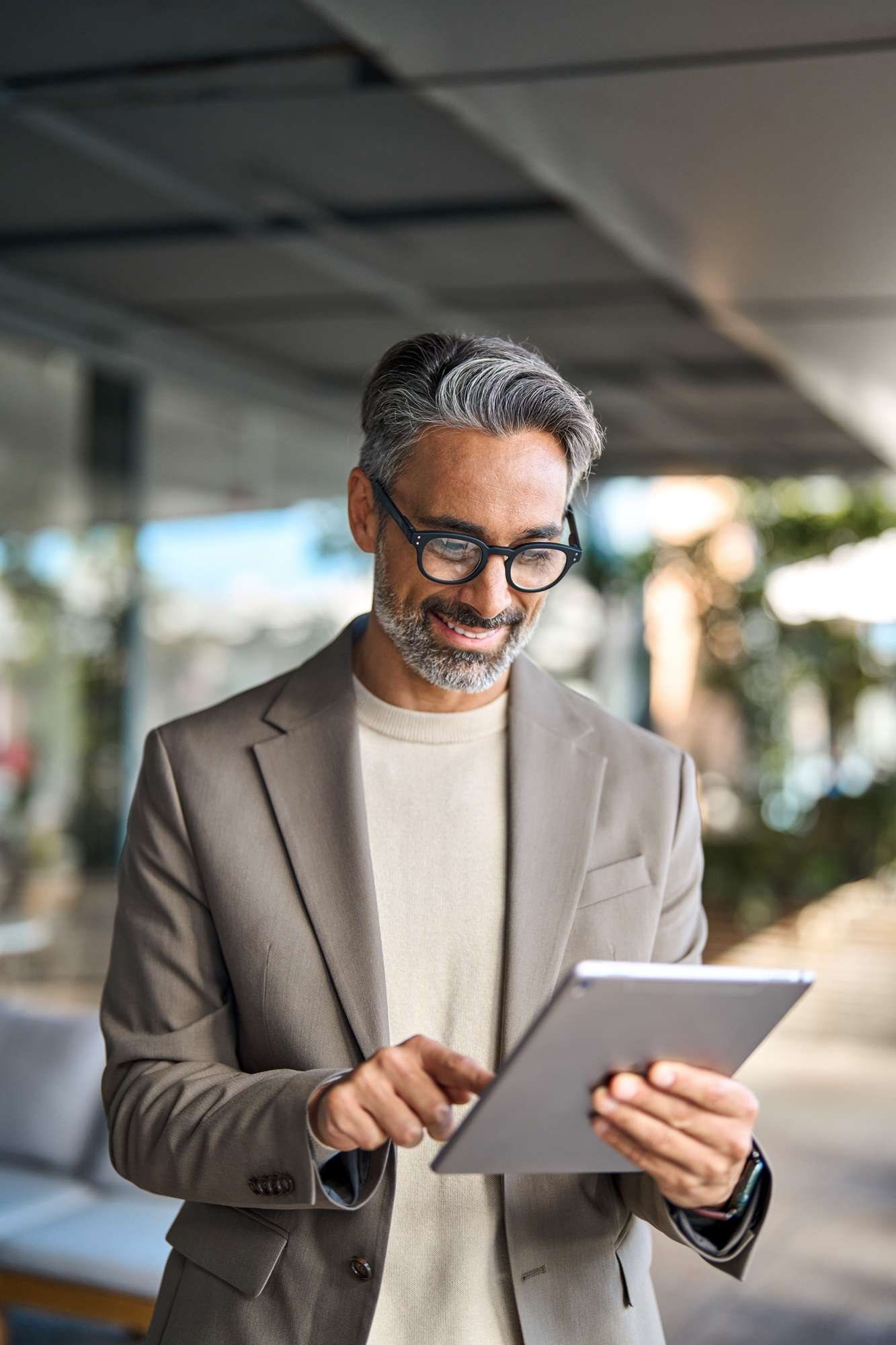 Email Marketing Campaigns 2 Busy happy older business man standing outdoors using digital tablet. Vertical.