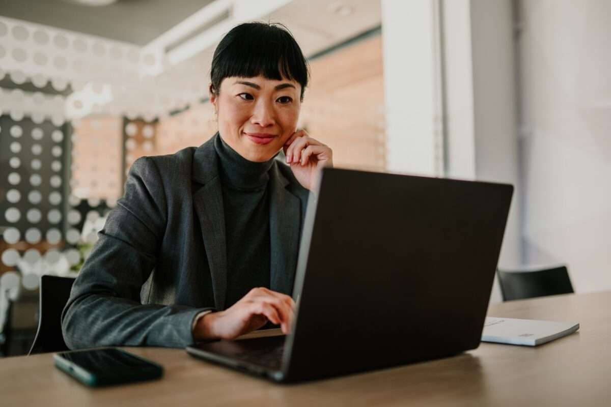 Businesswoman working on laptop in modern office