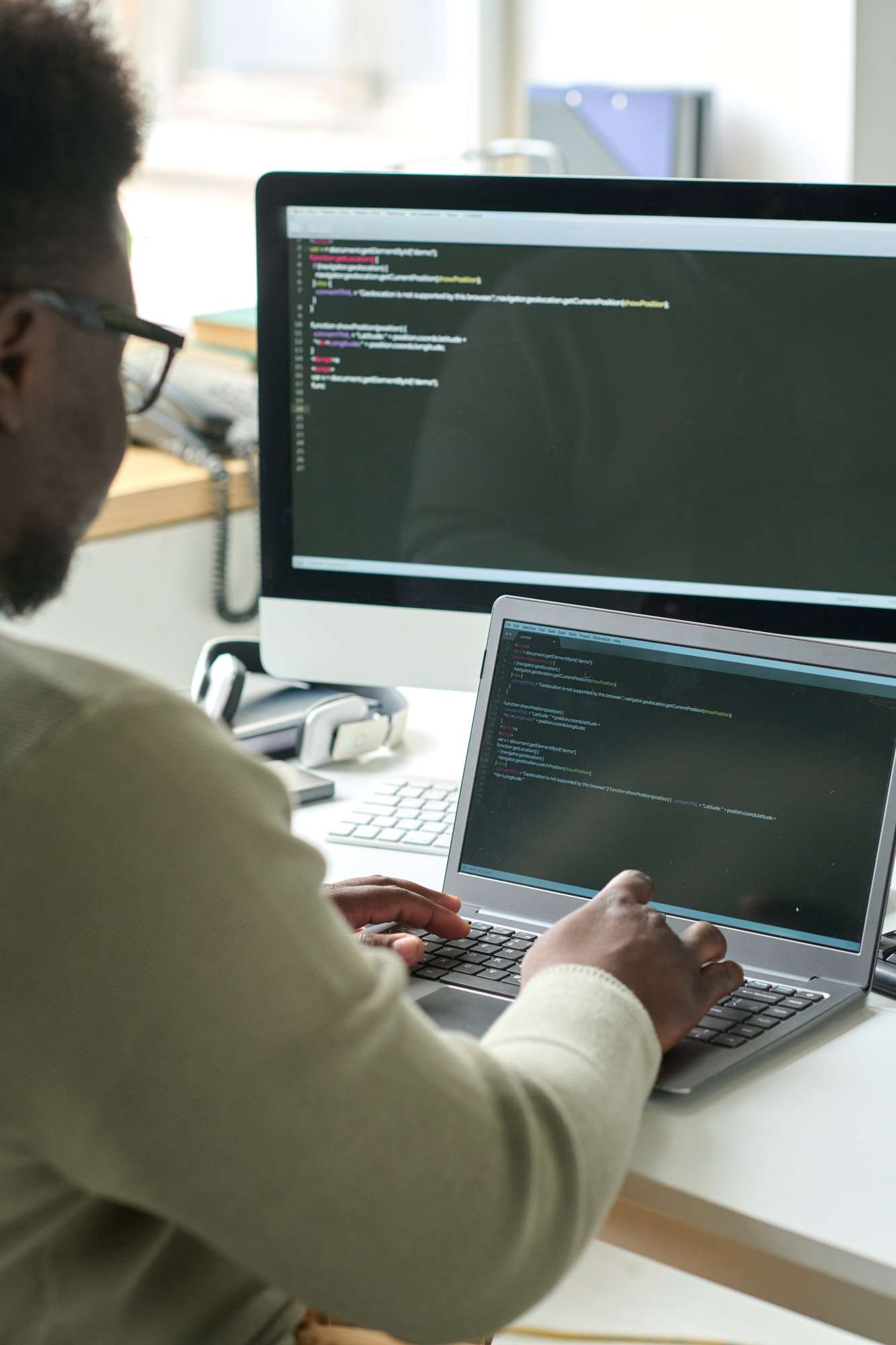 Dedicated Technical Support 2 Programmer developing new software on laptop
