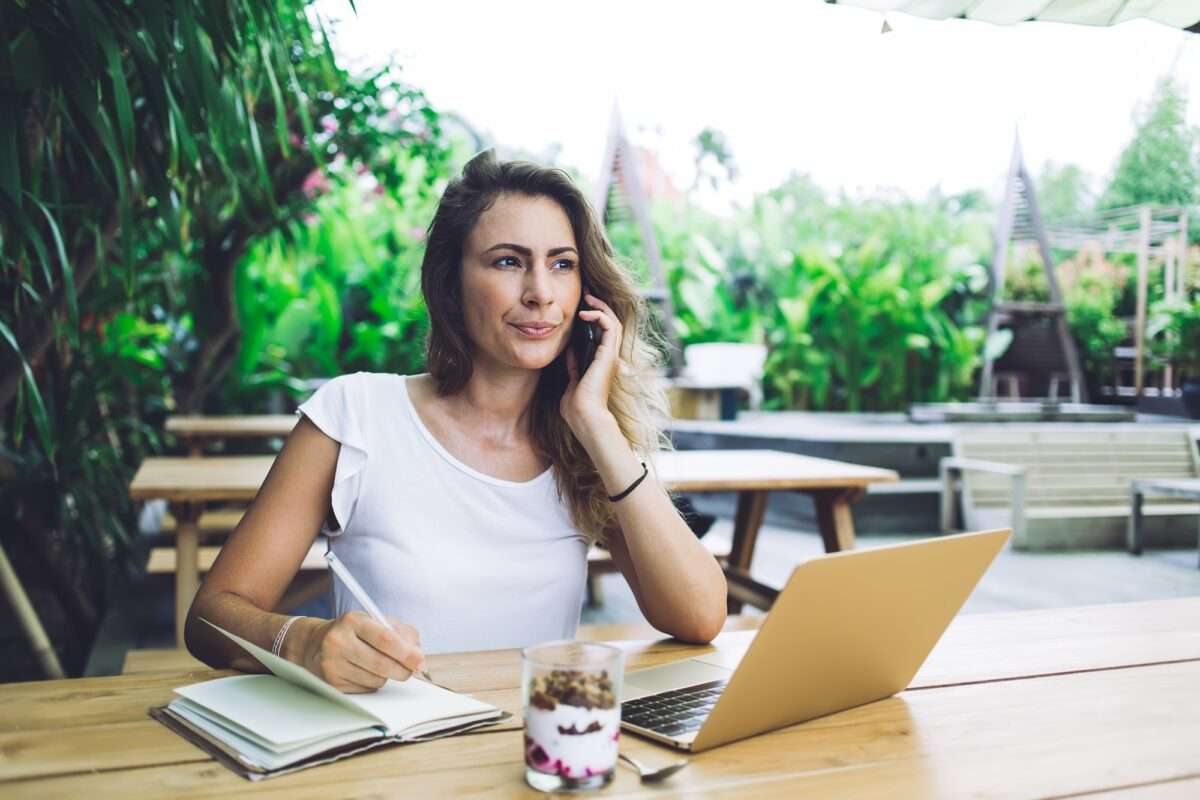 10 Ways DIY Websites Sabotage Small Businesses (And How to Avoid It) 6 Sceptical female working on laptop in open air cafe while talking on mobile