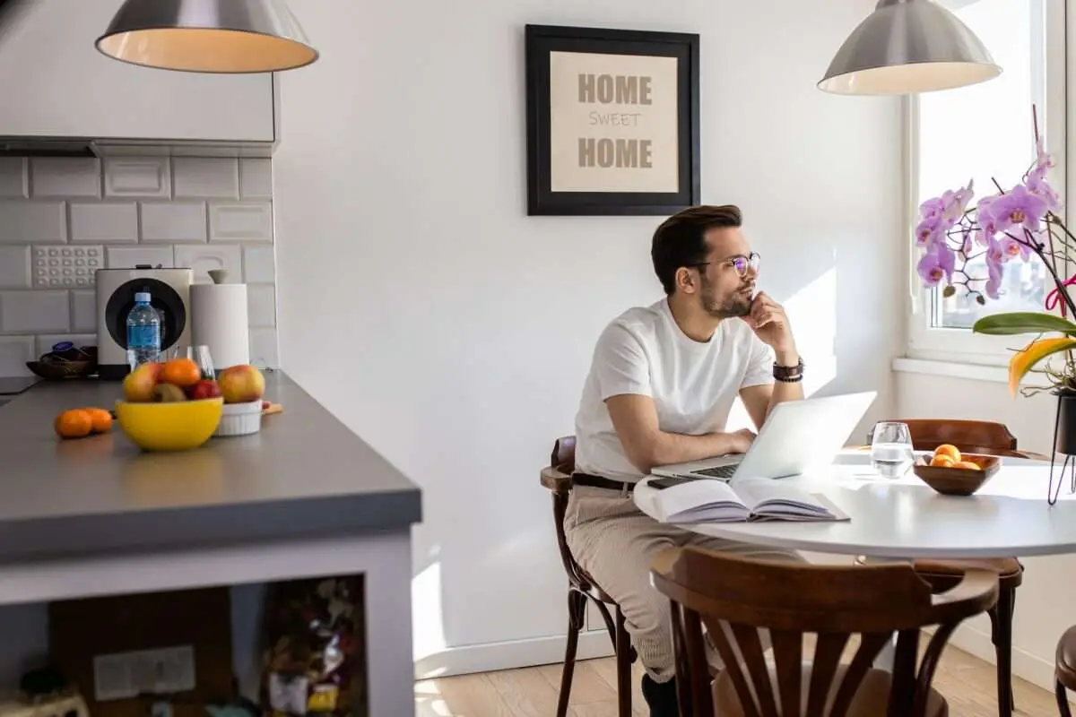 Man working at home using laptop contemplating content promotion strategies