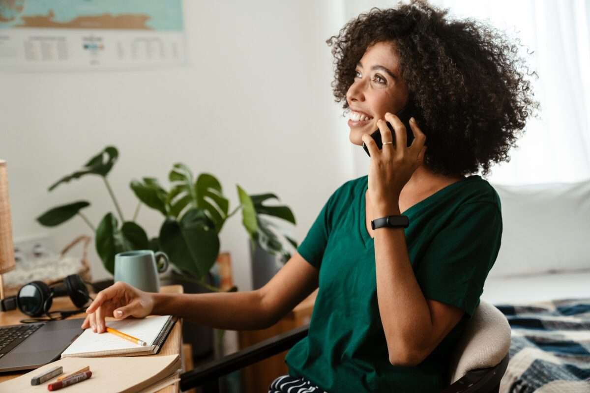 African american woman talking on cellphone and booking a call with a local service business in one minute
